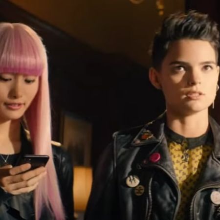 Brianna Hildebrand is talking as Shioli Kutsuna is on her phone.
